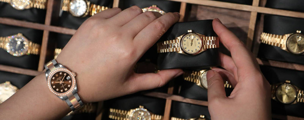 A close-up of a luxury watch with a price tag or shipping label ready to be sent to a buyer.