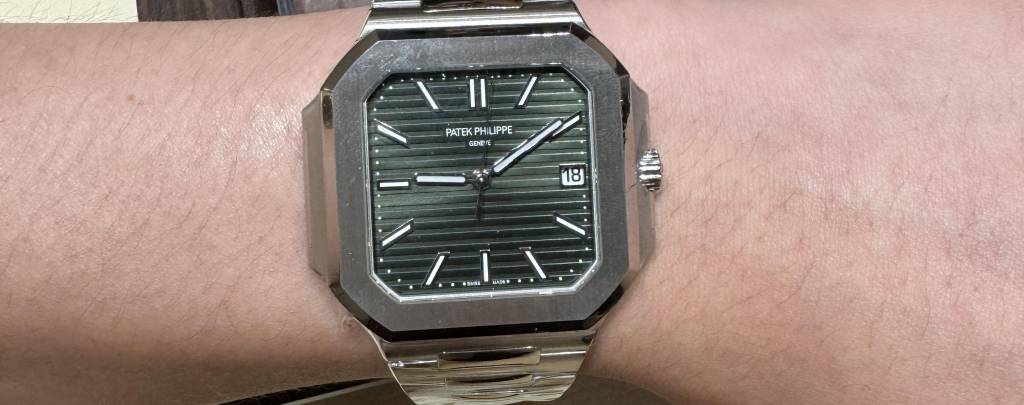 A close-up shot of the Patek Philippe Cubitus Ref. 5821/1A on a wrist, showcasing its square case and integrated bracelet.