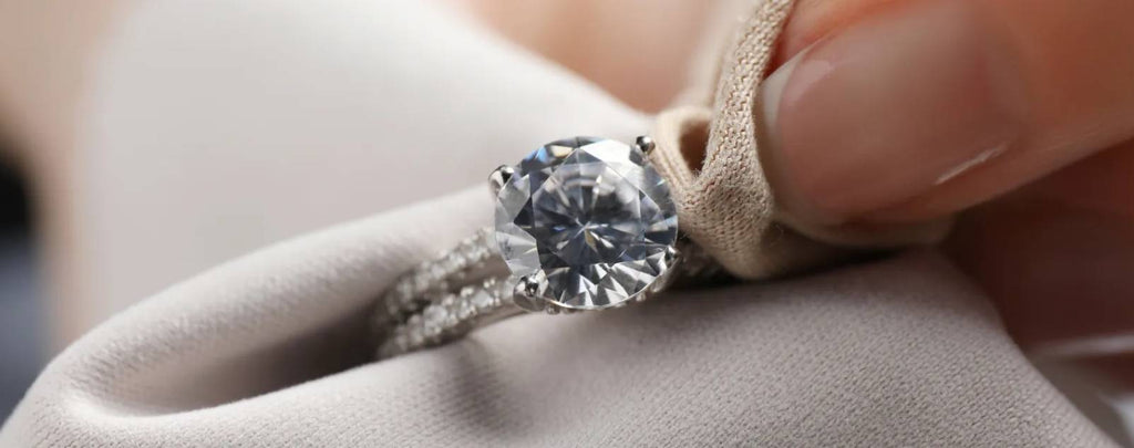 Magnifying glass inspecting a diamond ring for quality.