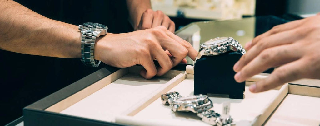 A Rolex watch being appraised by a professional jeweler for its condition and value.