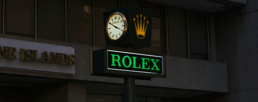 A watch dealer appraising a Rolex for a customer at their shop.