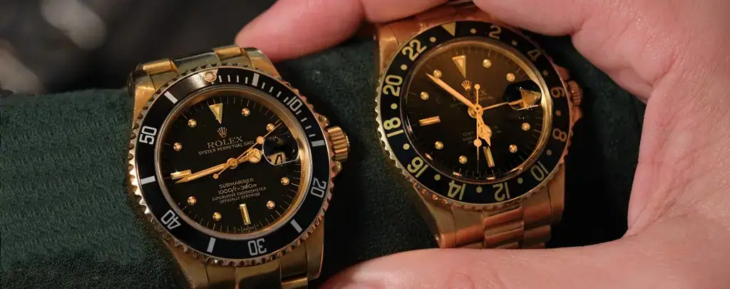 A luxury watch, such as a Rolex, being appraised by a jeweler.
