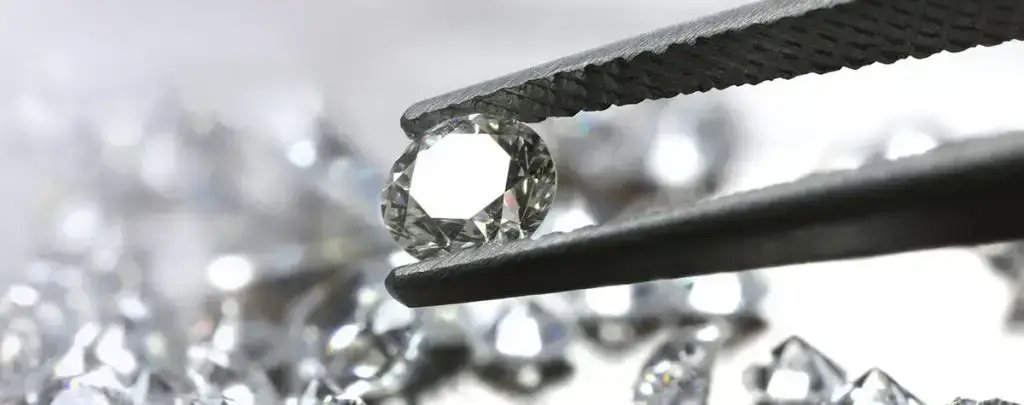 A person polishing or cleaning a diamond ring to prepare it for sale.
